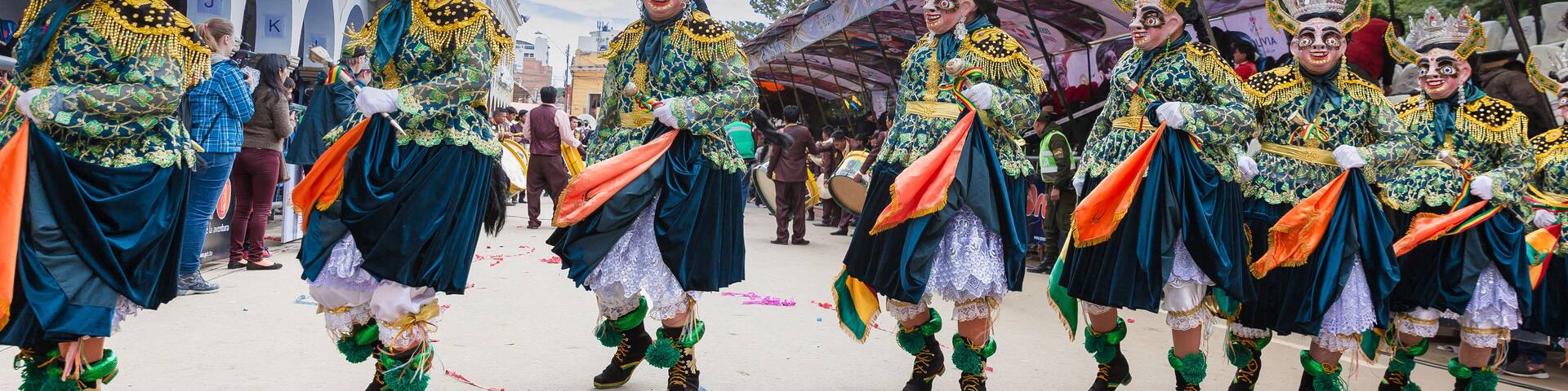 Oruro carnival in Bolivia with masked dancer during procession