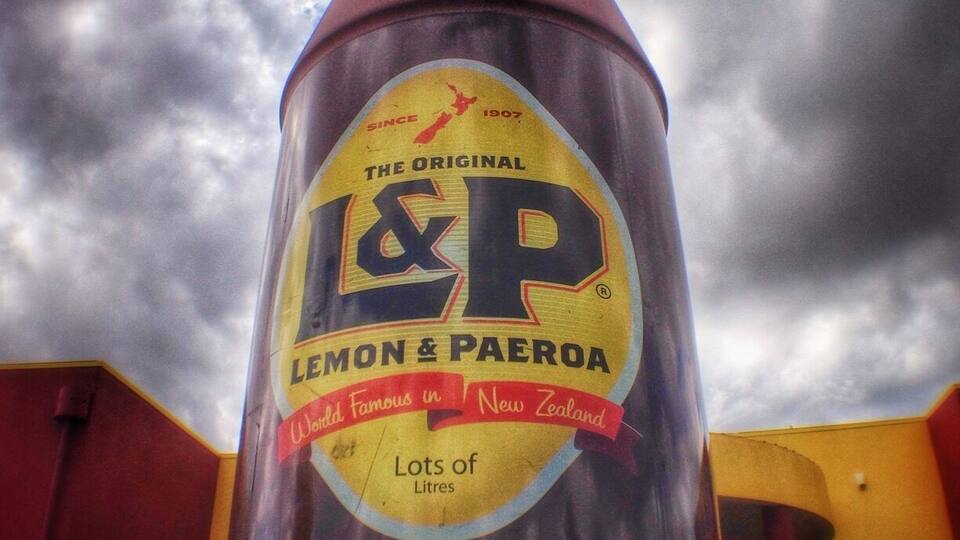 A large, conical structure with a yellow and red label that reads "Lemon & Paeroa" and "The Original I&P."