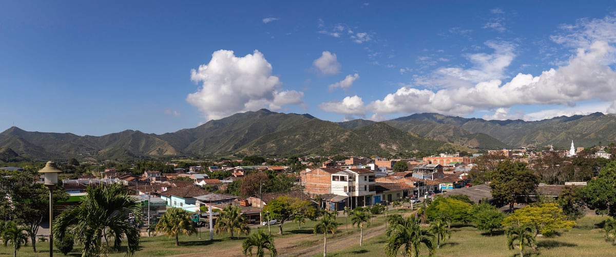 A town nestled between mountains with a clear sky.