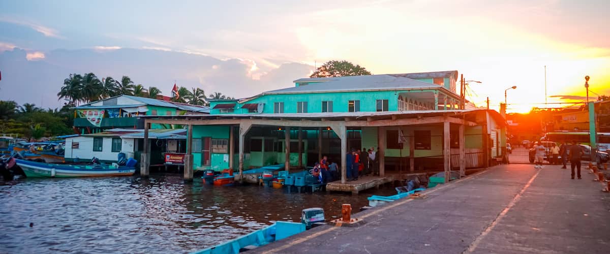 A waterfront building with boats docked in front.