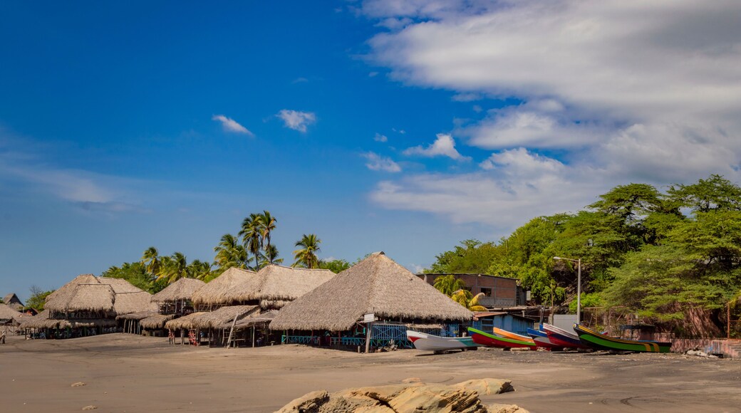 Thatched roof restaurants near the beach, thatched roof restaurant near wooden boats with blue sky, nicaragua restaurants near the beach