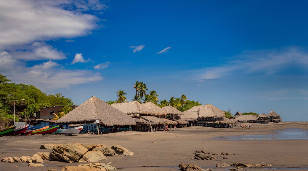 Thatched roof restaurants near the beach, thatched roof restaurant near wooden boats with blue sky, nicaragua restaurants near the beach