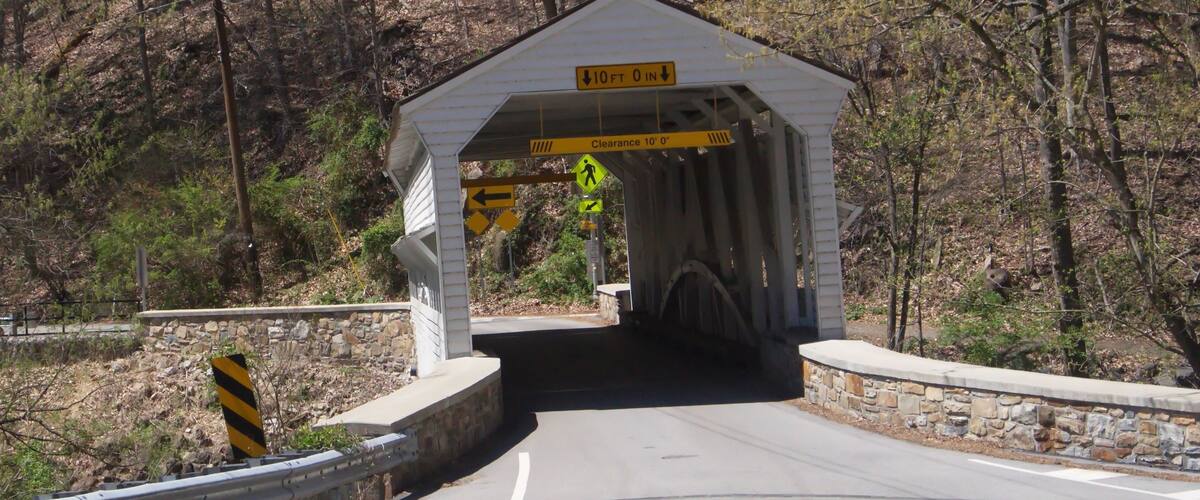 A covered bridge with a clearance sign of 10 feet 0 inches.