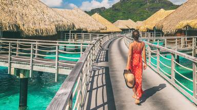 Luxury travel vacation destination panoramic banner. Romantic honeymoon getaway in overwater bungalows villas of Tahiti resort, Bora Bora, French Polynesia. Landscape copy space panorama.