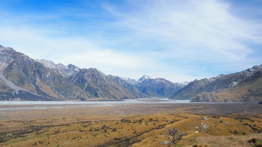Lord of the Rings country! From the rocky outcrop of Mount Sunday (used as the location of Edoras - home of the Rohan) there's a 360-degree view of the Southern Alps.
This was a highlight of our trip to New Zealand and is an easy walk from the Mount Sunday car park. The "Mount" itself is more of a hill really so don't be put off! Access is via a long, gravel track off State Highway 72 at Mount Somers (signposted Mt Potts).
Whether you're a LOTR fan or not, if you enjoy raw, spectacular scenery you shouldn't miss it.
Read more at http://www.aboveusonlyskies.com/mount-sunday-rohan/