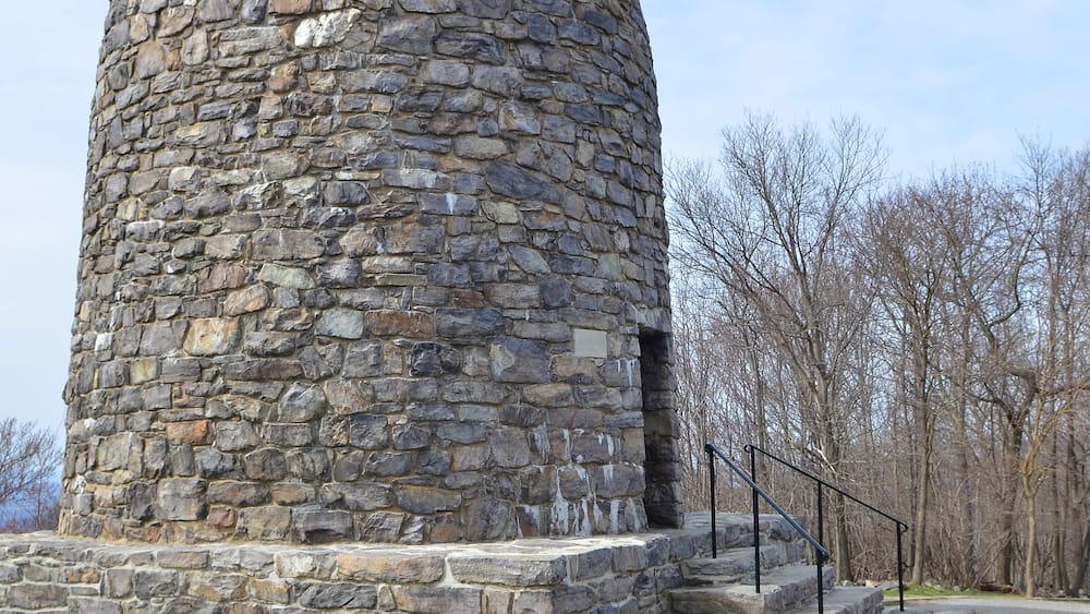 A stone tower with a staircase leading up to it.