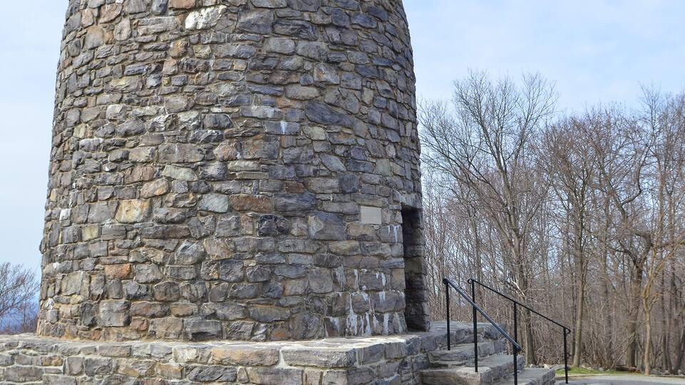 A stone tower with a staircase leading up to it.