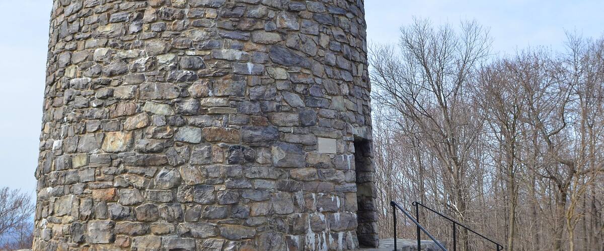 A stone tower with a staircase leading up to it.