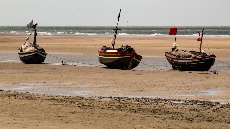 Some traditional boats stranded on the beach of Mangue Seco in Raposa Ma, Brazil