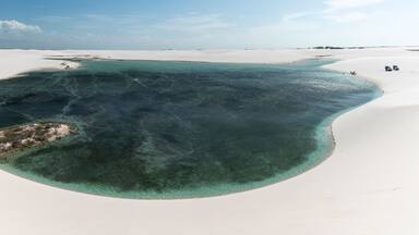 Beautiful view to blue rainwater lagoon on white sand dunes