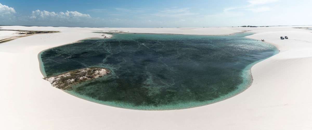 Beautiful view to blue rainwater lagoon on white sand dunes