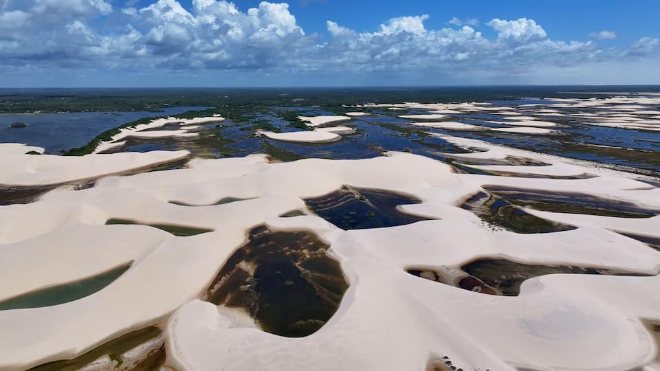 Terraced salt formations and a distant coastline.