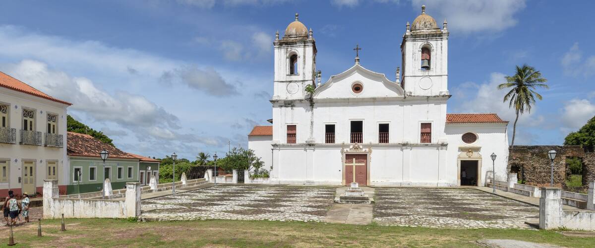 A historic church with two bell towers and a courtyard.