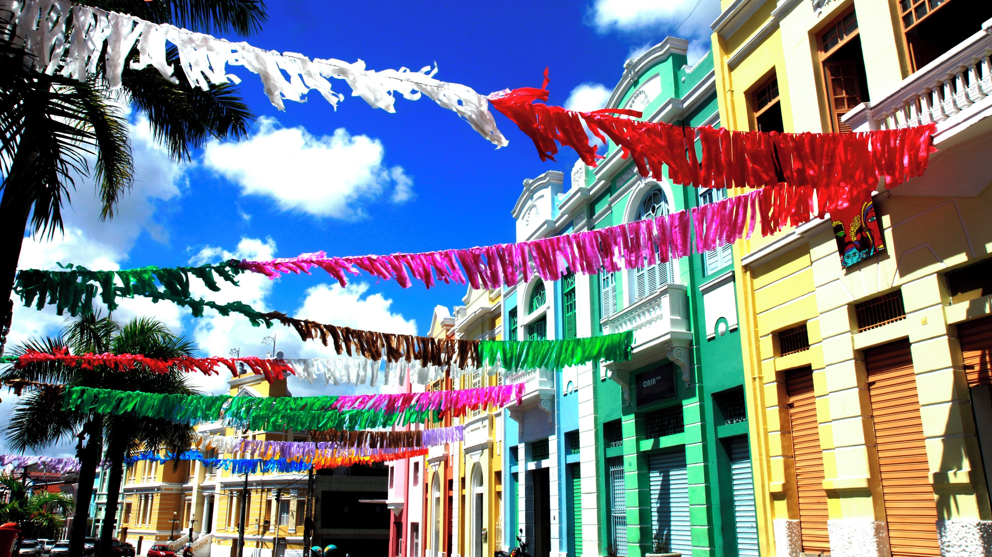 A street with colorful flags and buildings.