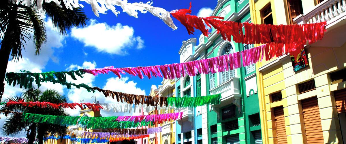 A street with colorful flags and buildings.