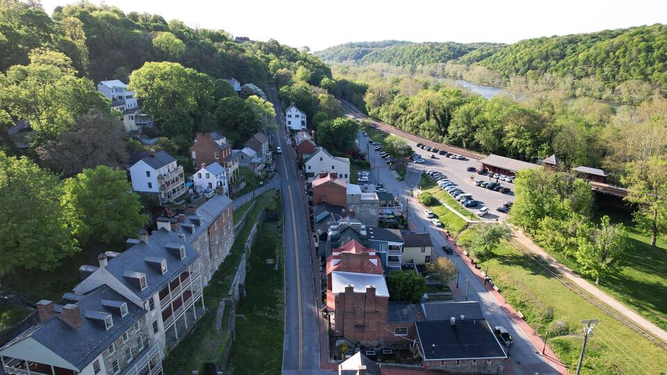 A town with historic buildings, a river, and a train track.