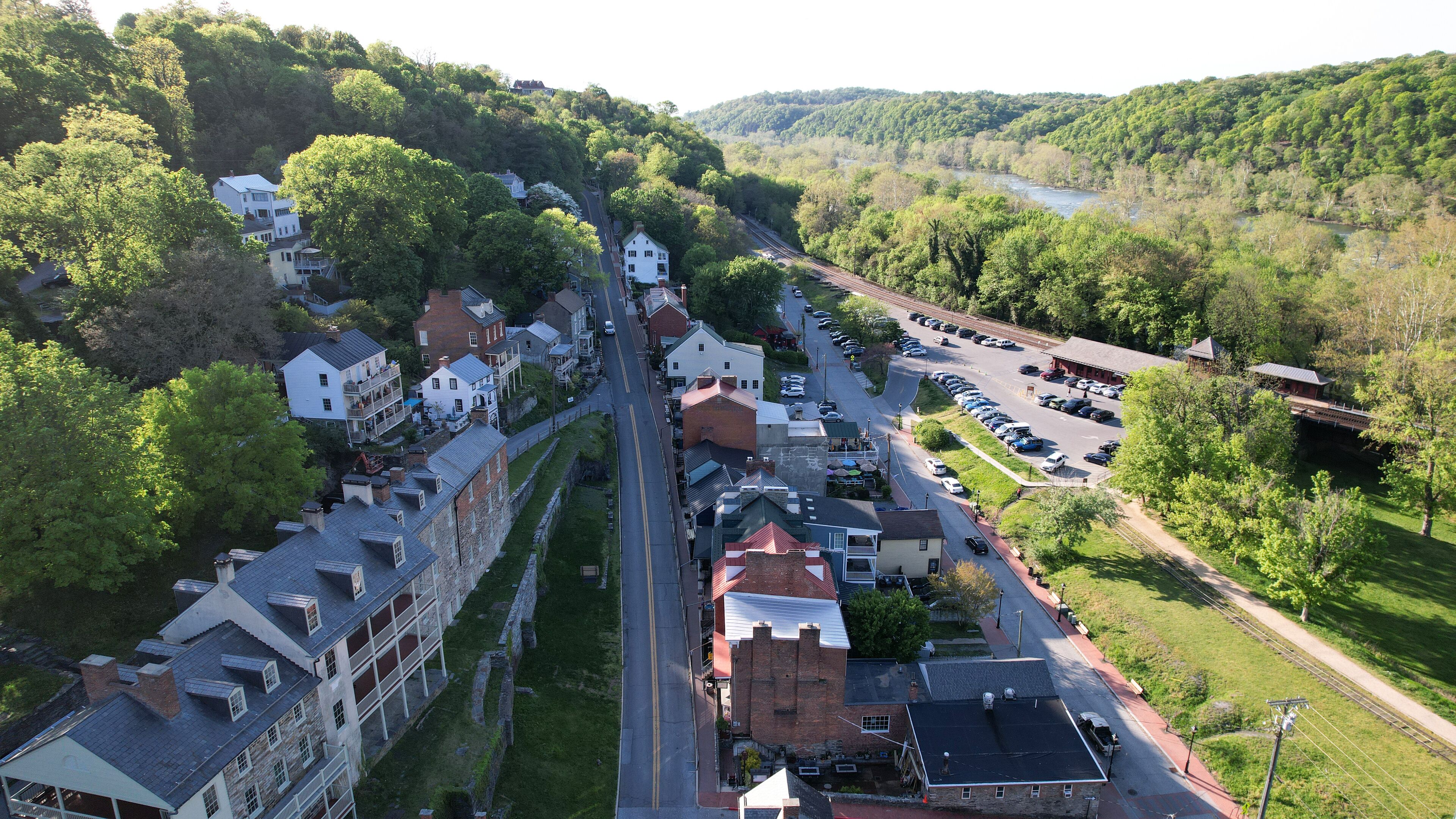 A town with historic buildings, a river, and a train track.