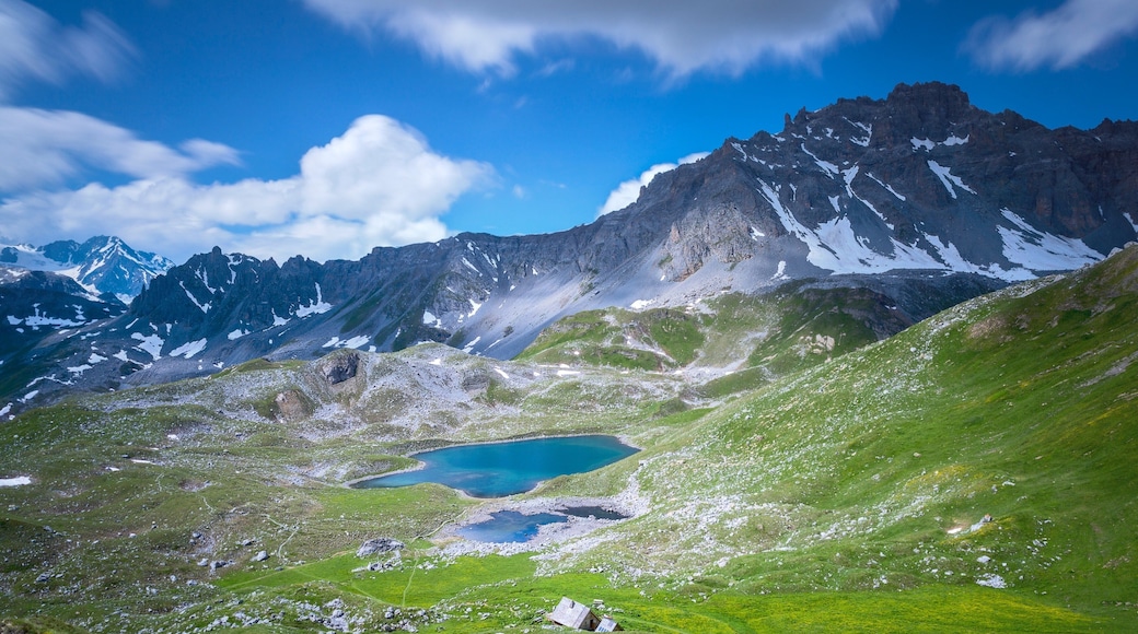 Courchevel Ski Resort featuring mountains, a lake or waterhole and landscape views