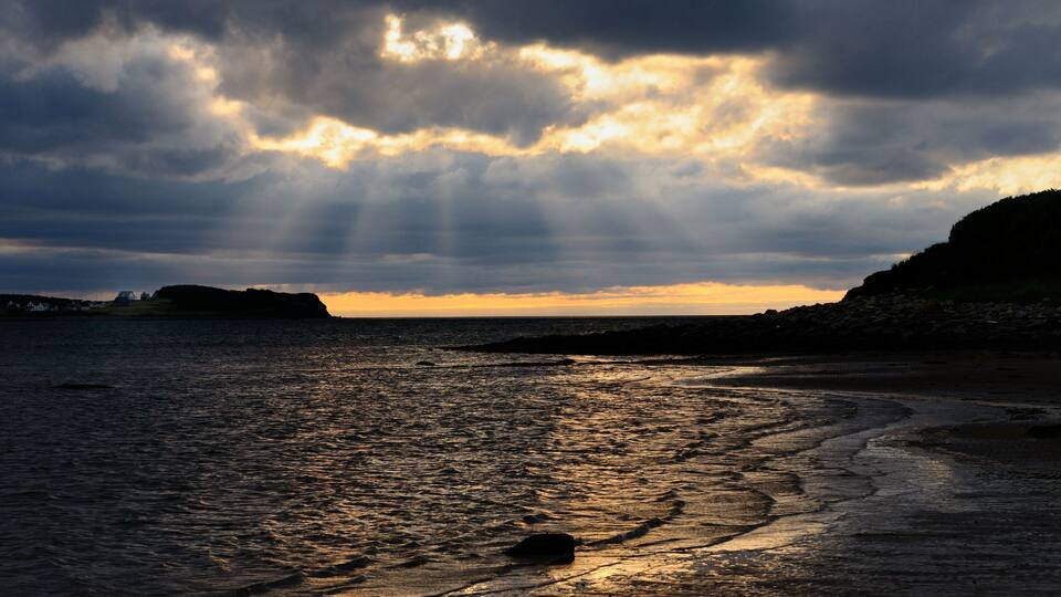 Shafts of sunlight at Port Hood shores Cape Breton Island Nova Scotia