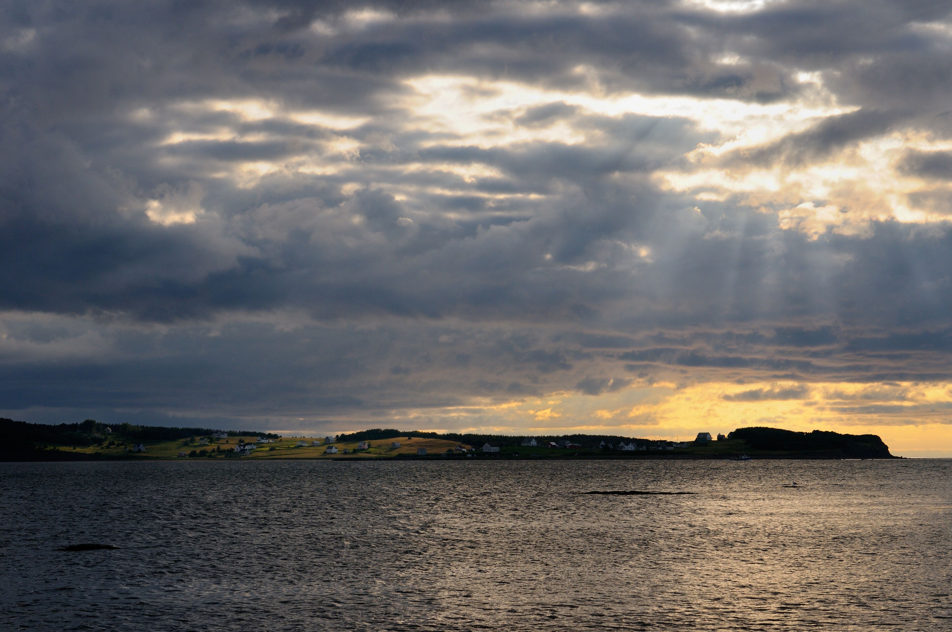 Gods Rays and shaft of sun on Port Hood Island farmland Cape Breton Nova Scotia