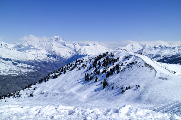 Ski slopes on a hill with snowy, mountain peaks in the background, La Plagne, Alps, France, Shutterstock ID 529943059, Purchase Order: -