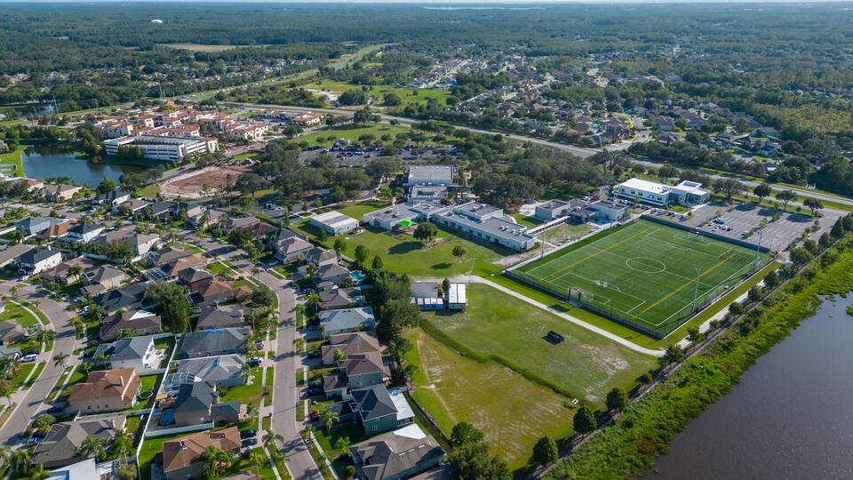 UAV shot of neighborhood near Clearwater Florida with cityscape and green environment by drone