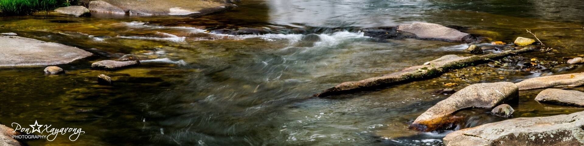 French Broad Falls in the North Carolina mountains near the Blue Ridge Parkway. The North Fork of the French Broad River drops 15 feet to create French Broad Falls just before it merges with Shoal Creek