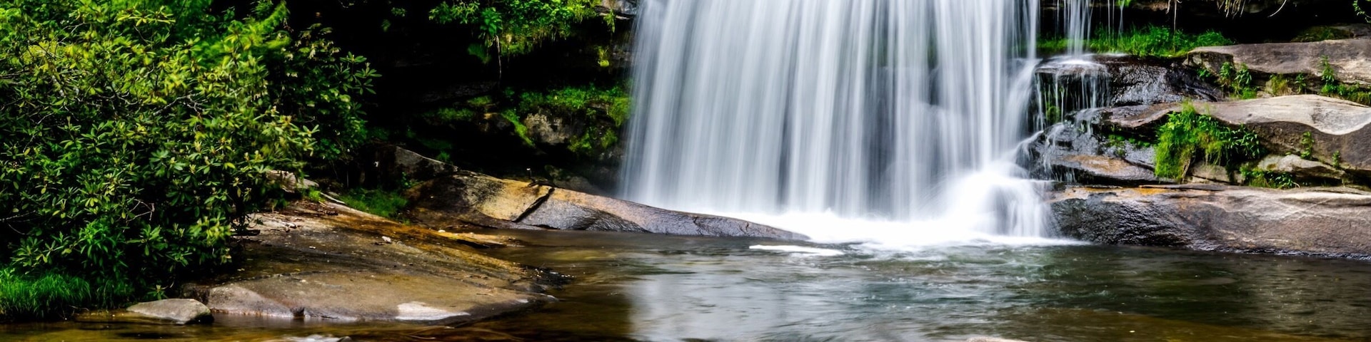 French Broad Falls in the North Carolina mountains near the Blue Ridge Parkway. The North Fork of the French Broad River drops 15 feet to create French Broad Falls just before it merges with Shoal Creek