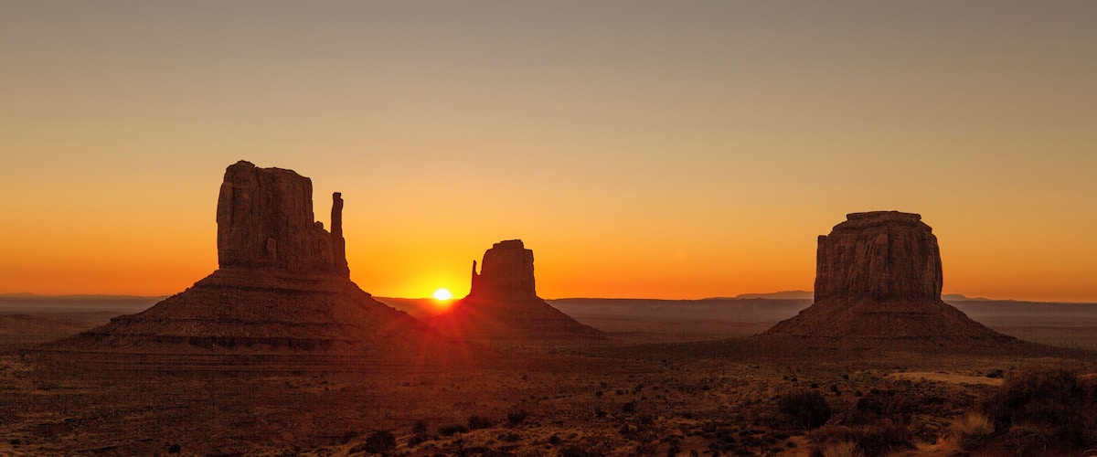 There is a campground inside Monument Valley. The Campground and the hotel are the only two places you can legally watch the sunrise come up over Monument Valley. The valley road is closed to non-residents during the night.
If you go to campground it is first come first serve, starting at noon. I would recommend going early and grabbing one of the prime spots. You will have an amazing view from your tent of the mittens coming up. This was mine.