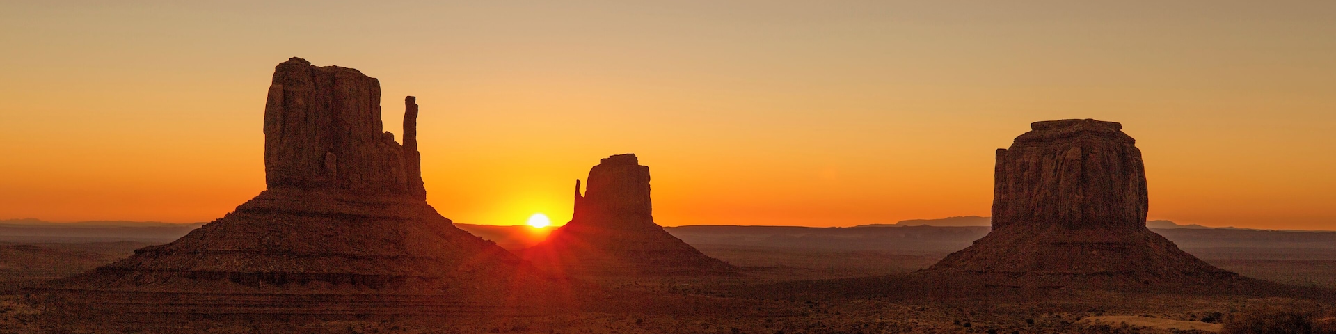 There is a campground inside Monument Valley. The Campground and the hotel are the only two places you can legally watch the sunrise come up over Monument Valley. The valley road is closed to non-residents during the night.
If you go to campground it is first come first serve, starting at noon. I would recommend going early and grabbing one of the prime spots. You will have an amazing view from your tent of the mittens coming up. This was mine.