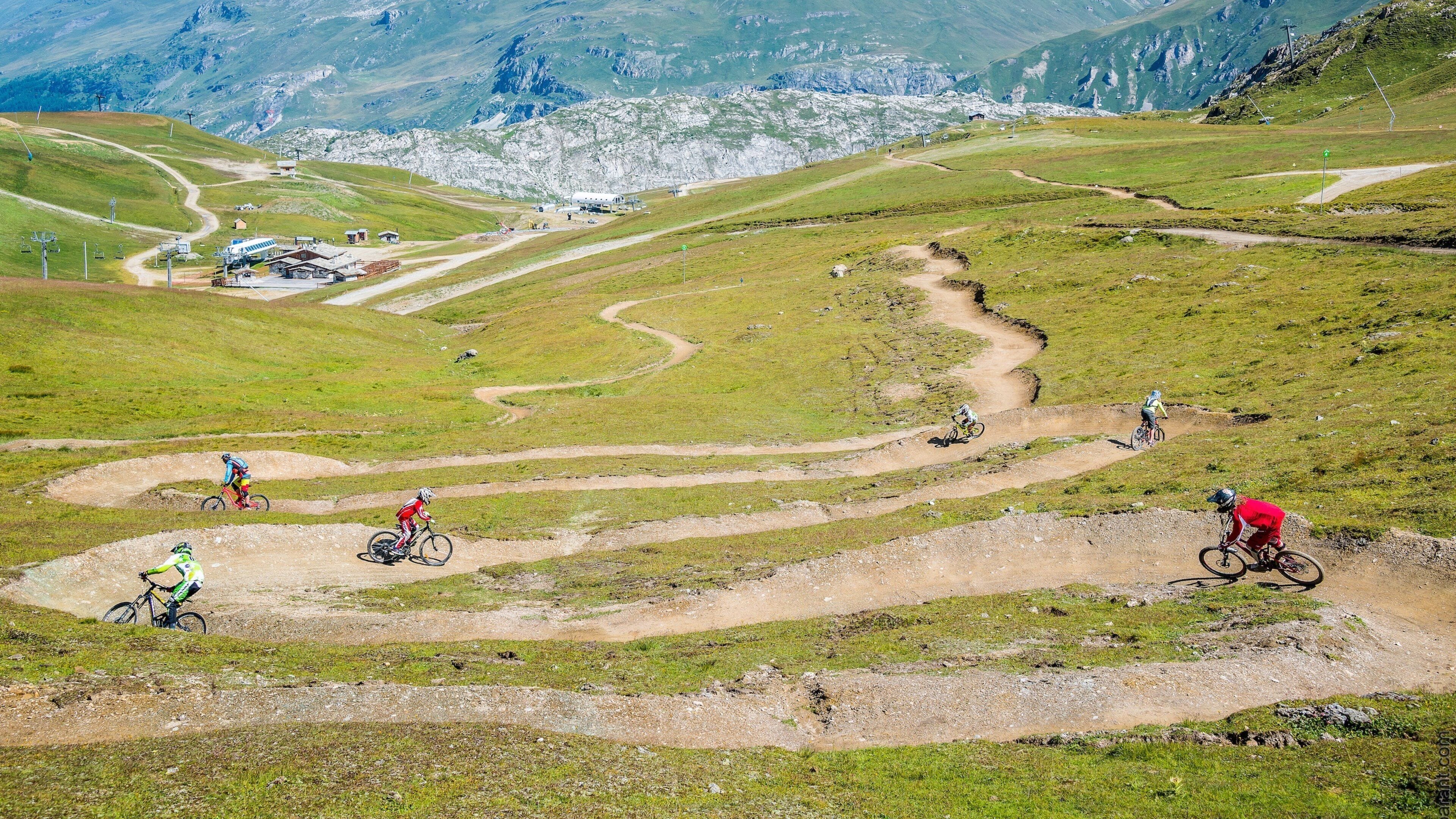 Val-d\'Isere showing mountain biking as well as a small group of people