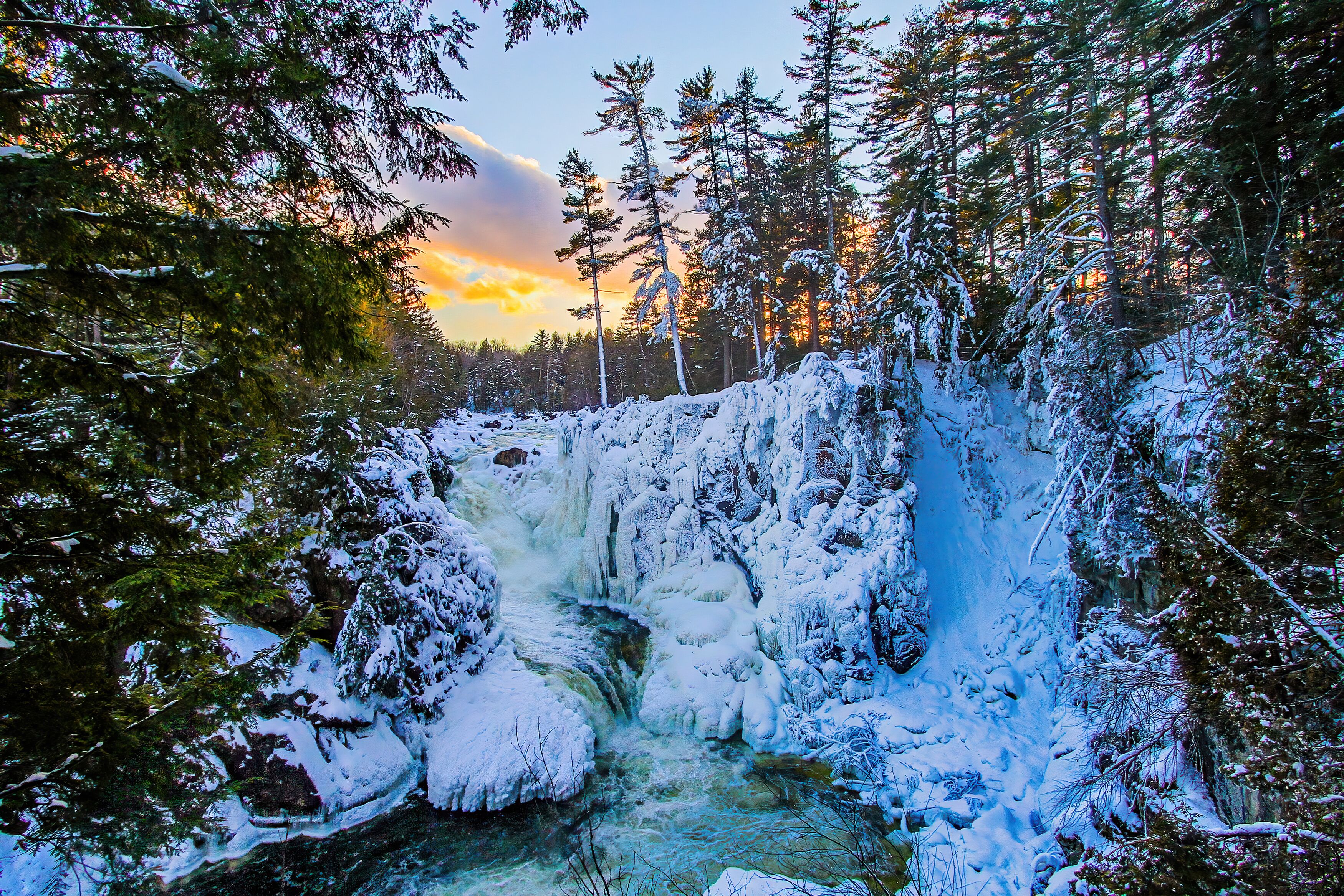 Winter wonderland at the frozen Dorwin Falls in Rawdon, Québec, Canada - Natural winter landscape of a narrow canyon going through a maple forest covered with snow