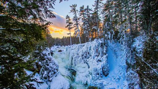 Winter wonderland at the frozen Dorwin Falls in Rawdon, Québec, Canada - Natural winter landscape of a narrow canyon going through a maple forest covered with snow