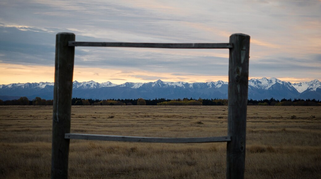 Two wooden poles create natural picture frame with New Zealand Southern Alps mountain panorama at Dog Kennel Corner