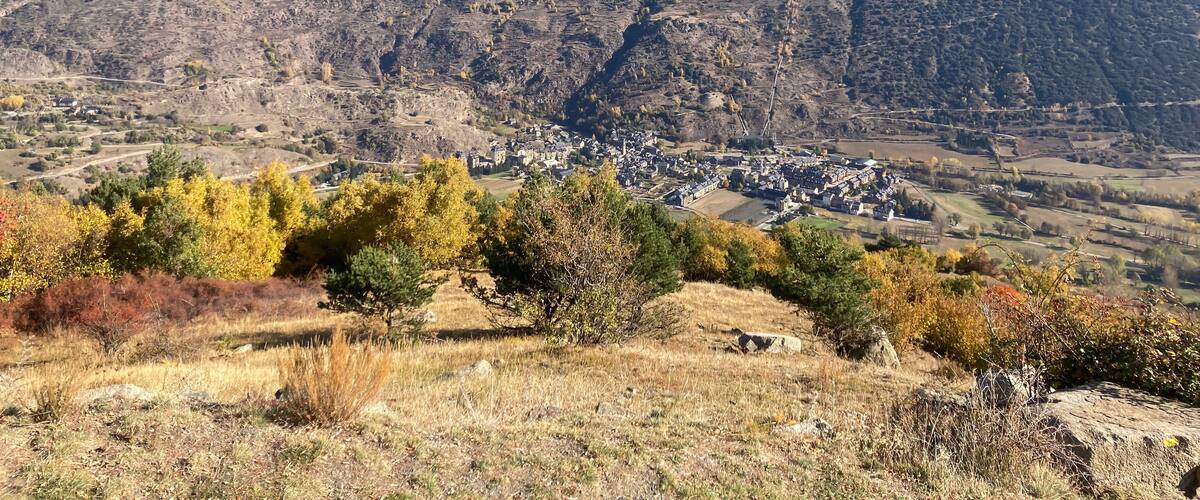 A mountainous landscape with a small village nestled in a valley.