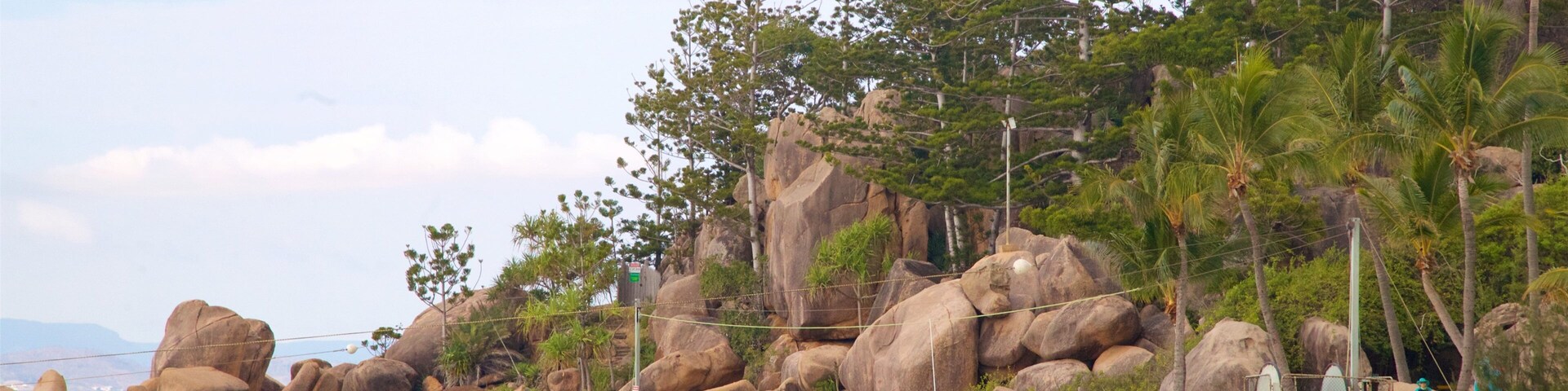 Picnic Bay featuring rocky coastline, tropical scenes and a sandy beach