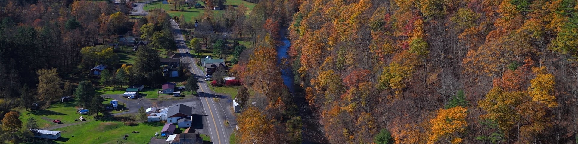 Countryside with Mountains in Autumn Fall colors with houses in grassy valley in Pennsylvania near Morris, PA