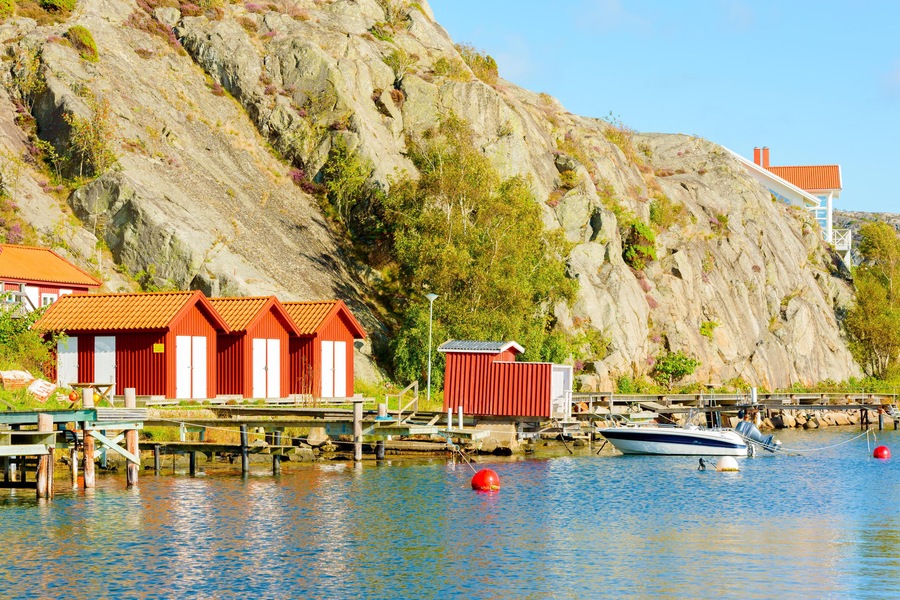 Nosund, Sweden - September 9, 2016: Everyday documentary of local boathouses and steep cliffs along the seaside promenade.