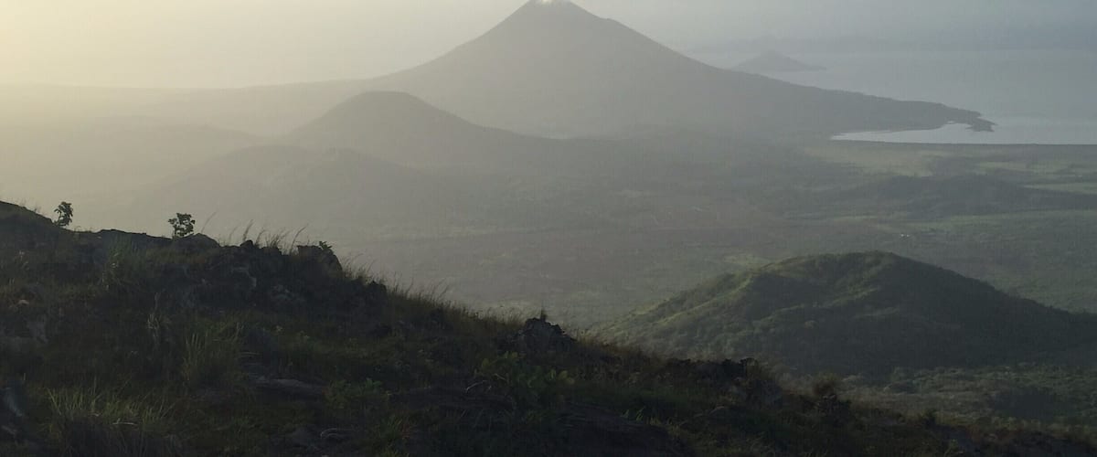 A mountain with a lake in the background.