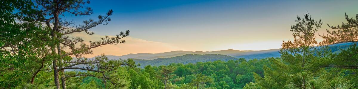 Exposed rock face with large boulder at sunset.