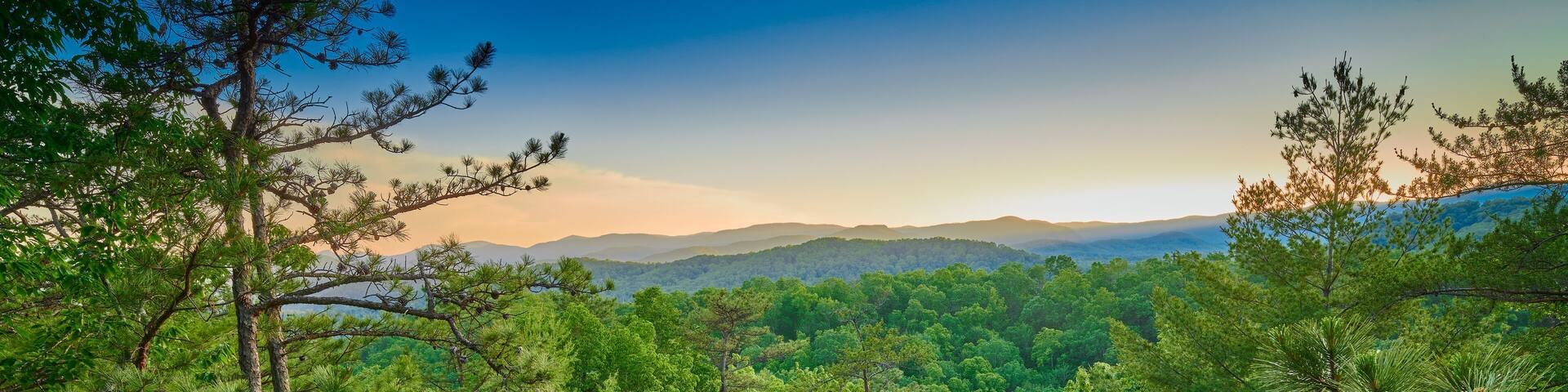 Exposed rock face with large boulder at sunset.