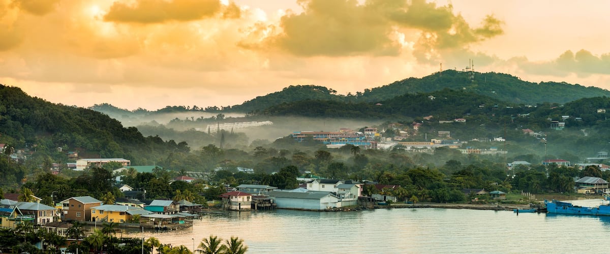 Panorama of Coxen Hole, Roatan with fog in first morning light.
