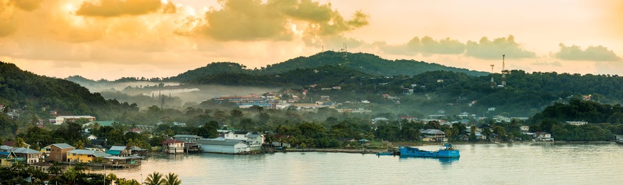 Panorama of Coxen Hole, Roatan with fog in first morning light.