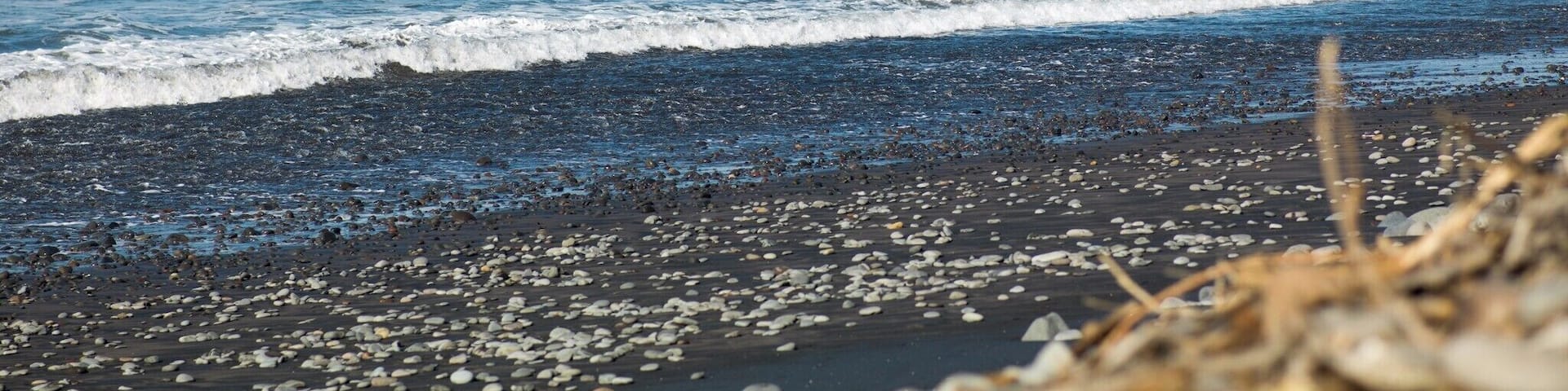 A rocky coastline with waves crashing against the rocks.