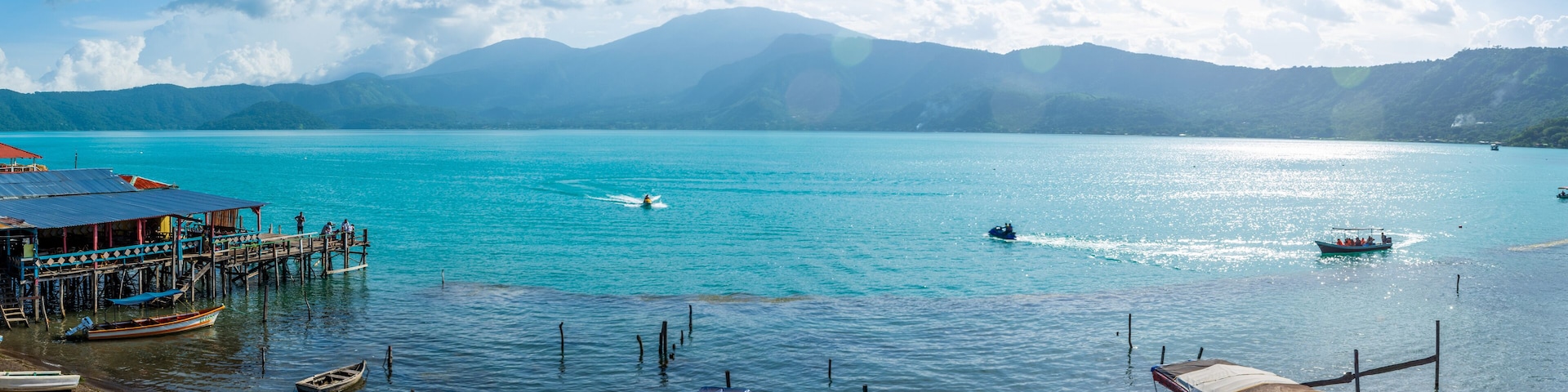 Boat with tourists crossing the lake of Coatepeque in El Salvador, Central America