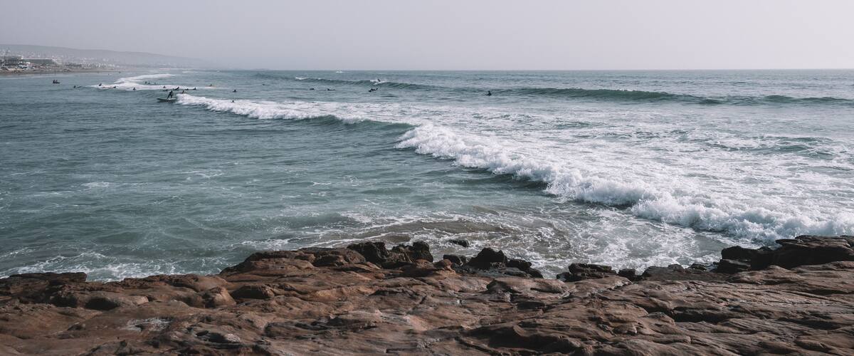 Surfers surfing the Waves of Taghazout at the West Coast of Morocco, Africa