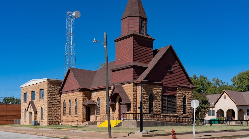 A church with a tall steeple and a clock tower.