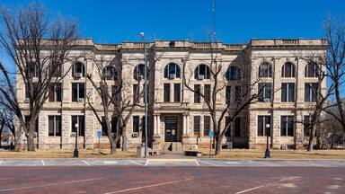A historic stone building with arched windows and a central entrance.