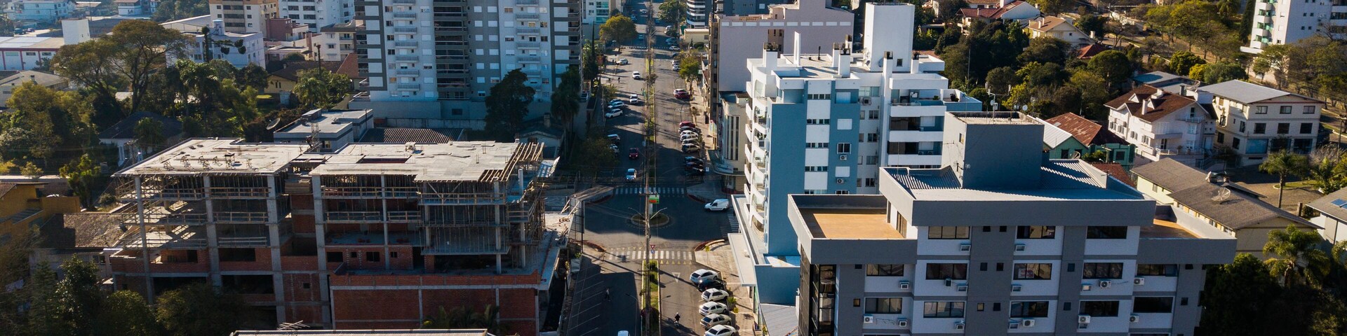 A cityscape with various buildings, roads, and a clear sky.