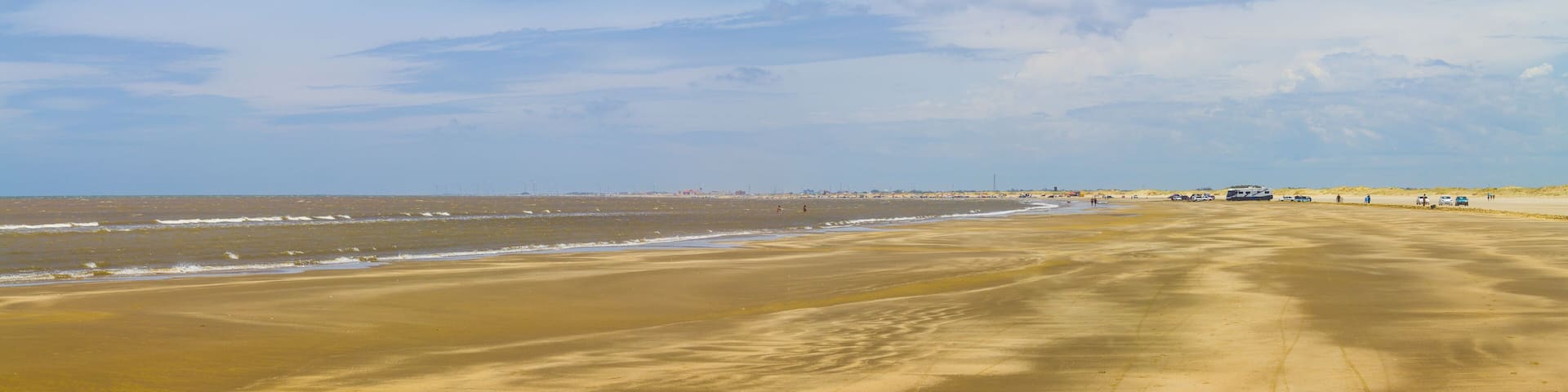 People, cars and sand in Cassino beach